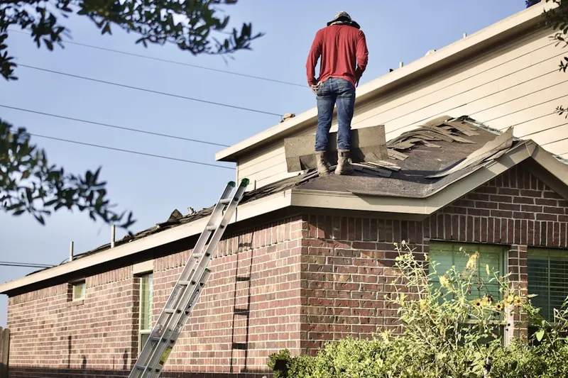 Professional roofer working on a residential roof in Gallagherville